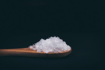 Salt flakes on a wooden spoon