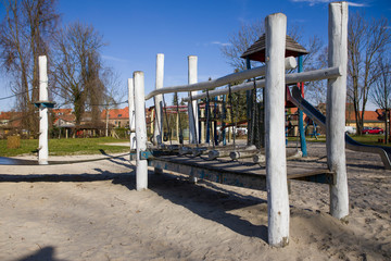 An empty playground with a swing in a natural environment