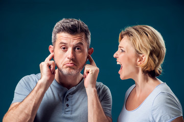 A portrait of angry couple. Wife screaming at her husband. People and emotions concept