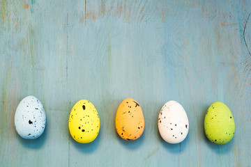 Easter eggs on blue wooden background.
