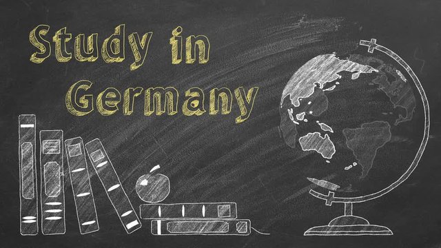 Lettering "Study in Germany", rotating globe and school books are drawn with chalk on a blackboard. Study abroad concept.