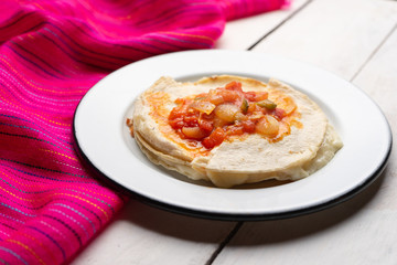 Mexican quesadilla with corn tortilla and piquant sauce also called 