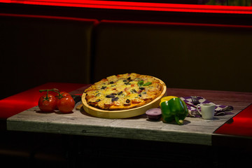 a slice of pizza and coffee in a Cup on a wooden table