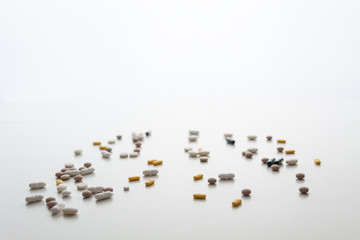 White background with scattered tablets. Bright medical background. Copy space. Minimal composition. Isolated.