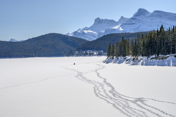 Footprints on frozen Lake Minnewanka in Banff National Park, Alberta, Canada
