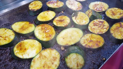 Roasting round slices of zucchini, vegetarian cuisine.