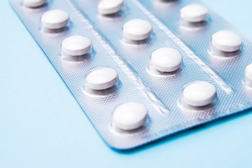 Medicine pills in blister packs. Tablets on a blue background
