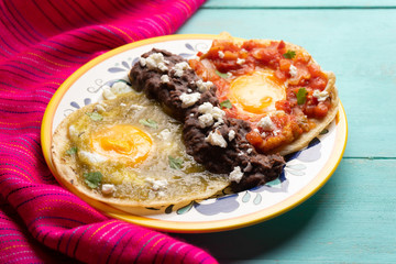 Mexican fried eggs with green and red sauce also called 