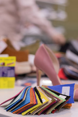 New colorful footwear with high heel on racks in shopping mall with copyspace