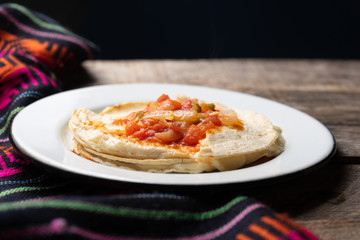 Mexican quesadilla with corn tortilla and piquant sauce also called 