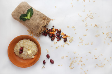 Oatmeal with butter. Healthy eating concept. View from above. dried berries