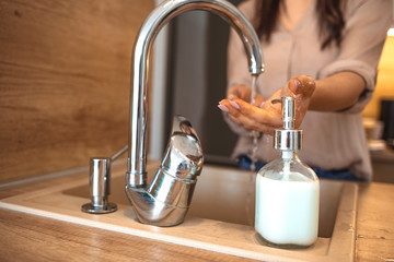 Woman Washing Her Hands. Hygiene concept. Washing hands with soap under the faucet with water. Woman washing hands indoors, closeup. Hygiene. Cleaning Hands.