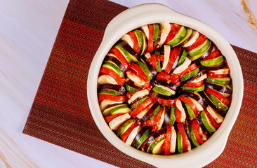 Uncooked sliced vegetables in sauce ready for cooking ratatouille.