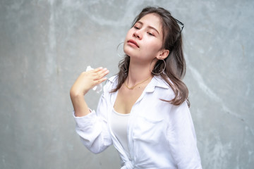 Asian beautiful woman with yellow skin, long black hair, wearing a white shirt, jeans showing her emotions.  Cement wall background-01