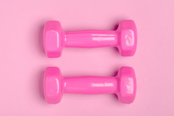 Top view on pink dumbbells. Equipment for fitness