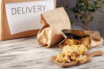 The frozen pasta in a paper bag. Food delivery online order. Quarantine concept.