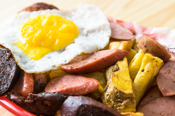 Peruvian salchipapa: hot dog with fried egg and potatoes