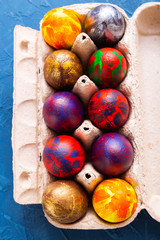 Handmade painted Easter eggs in egg box, close-up