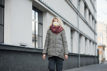 COVID-19 Pandemic Coronavirus Young girl in city street wearing face mask protective for spreading of Coronavirus Disease 2019. Close up of young woman with surgical mask on face against