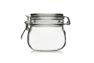 Empty glass jar for food storage isolated on a white background.