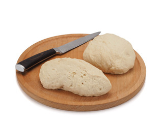fresh raw sliced dough on wooden board and knife isolated on white background