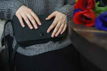 Woman with a small black bag over her shoulder