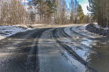wet dirty curved asphalt road