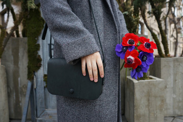 Woman with a small black bag over her shoulder