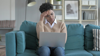 The Upset Young African Girl Sitting on Couch And getting Stressed