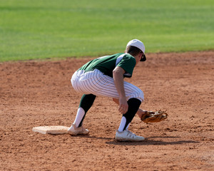 Young Boy catching and throwing the ball during a competitive baseball game