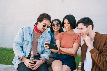 Group of friends watching something in smartphone.