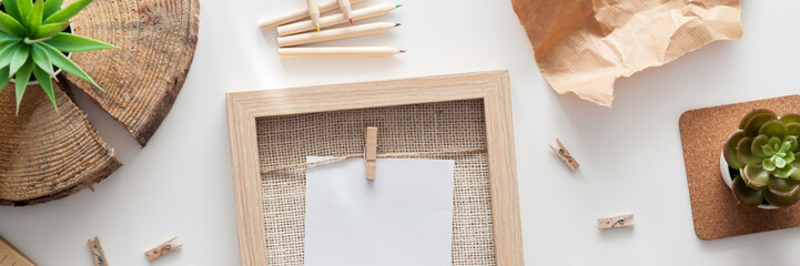 Creative home desk from above. Mockup frame. Empty space for text. Trunk slices as a decoration. Succulents. Natural and eco style. Panorama