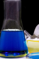 Petri dish and retort blue chemical reagent. Chemical experiment with Laboratory glass