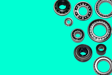 Car bearings collage on isolated aqua menthe  background. Bearings close-up advertising store. Banner on the website.