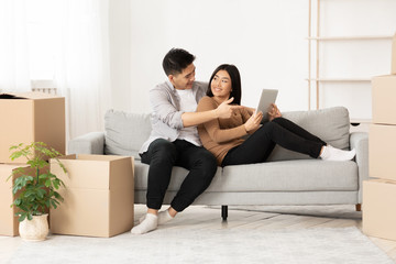 Asian couple discussing design of new appartment