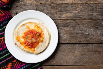 Mexican quesadilla with corn tortilla and piquant sauce also called 