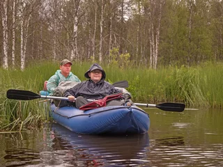 Foto op Canvas Father and son in kayak. Active holidays in Karelia. Water tourism. Ecotourism, visiting fragile, pristine, and relatively undisturbed natural areas © Natalia