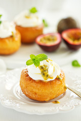 Rum woman (brioche) with cream and passion fruit. Dessert. Selective focus