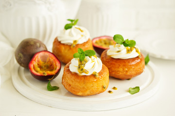 Rum woman (brioche) with cream and passion fruit. Dessert. Selective focus