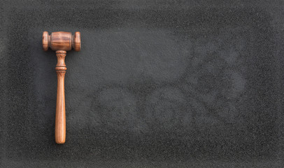judicial  wooden hammer on black asphalt