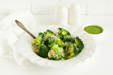 Broccoli cabbage with garlic and cheese with green sauce.