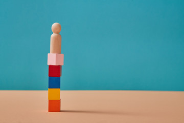 Goal achievement. Growth success process. Career ladder. Personal development. Wooden cubes stacking and person on top
