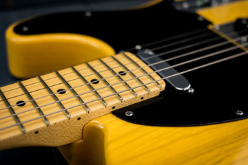 fretless electric guitar neck and pickup under steel strings