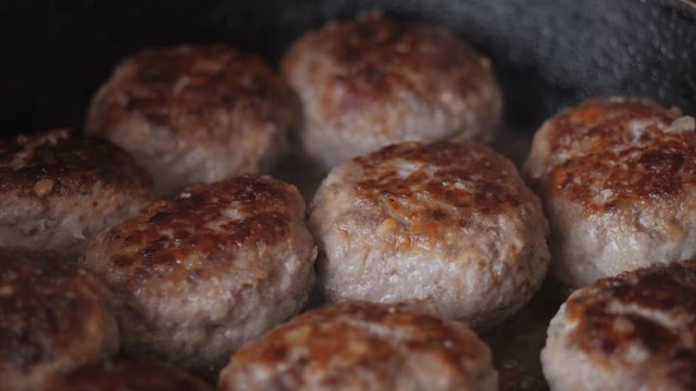 Home cooking. Roasting the meatballs in sunflower oil in a cast iron skillet.