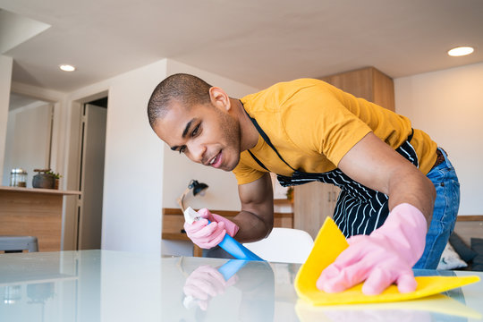 Young Latin Man Cleaning At Home.