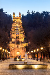 Naklejka premium Sanctuary of Nossa Senhora dos Remédios and monumental staircase in Lamego, Portugal, seen from the bottom of the staircase at dusk with the lighting on.