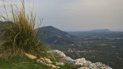  tall grass and stone on the background of mountains and green valley, Mountain Landscape