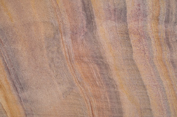 Colorful sandstone with layers on wall closeup