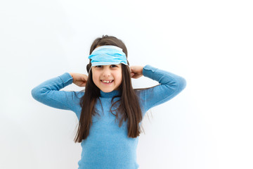 Little girl wearing a protective mask