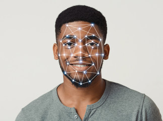 Cyber safety concept. Facial scanning of African American guy on light background
